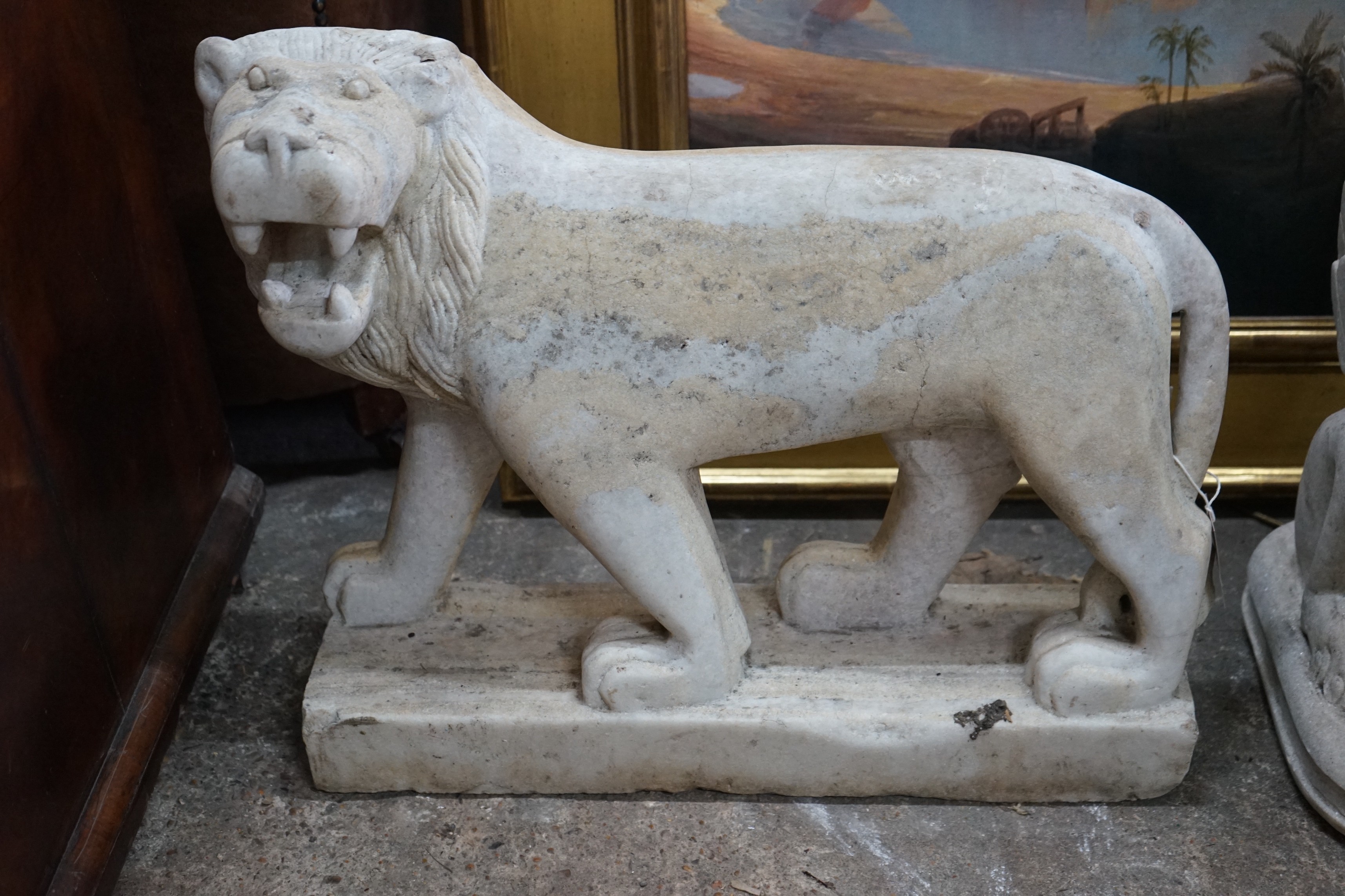 A South East Asian carved stone standing lion, width 60cm, height 50cm